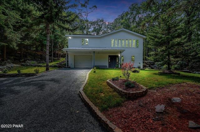 view of front property with a lawn and a garage