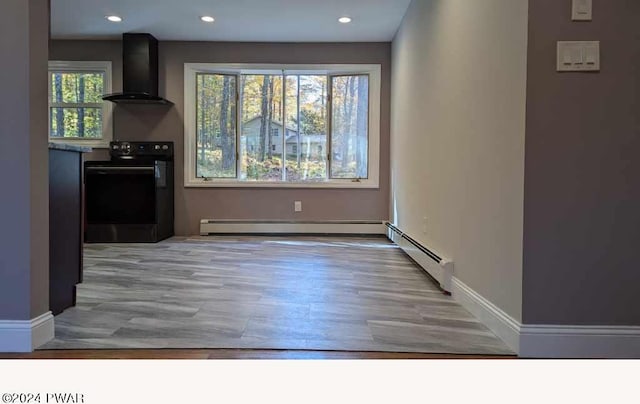 dining room featuring baseboard heating and light hardwood / wood-style flooring