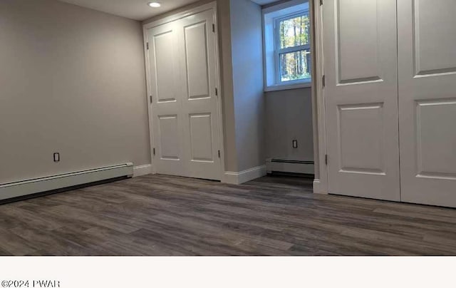 interior space with dark wood-type flooring and a baseboard radiator