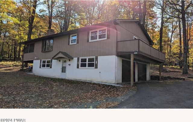 view of front of property with a balcony and a garage