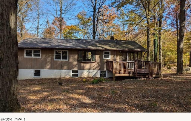 rear view of house with a wooden deck