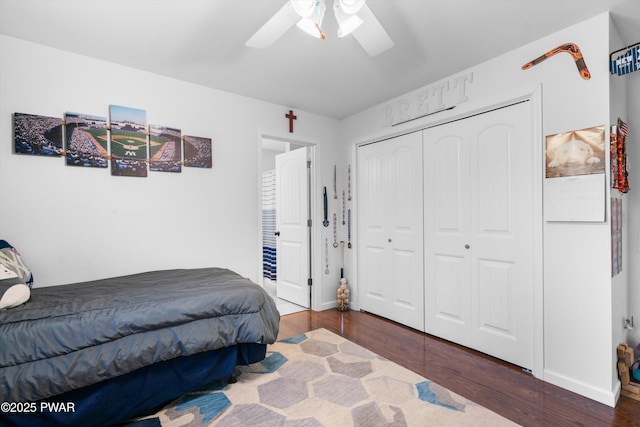 bedroom with dark wood-type flooring, a closet, and ceiling fan