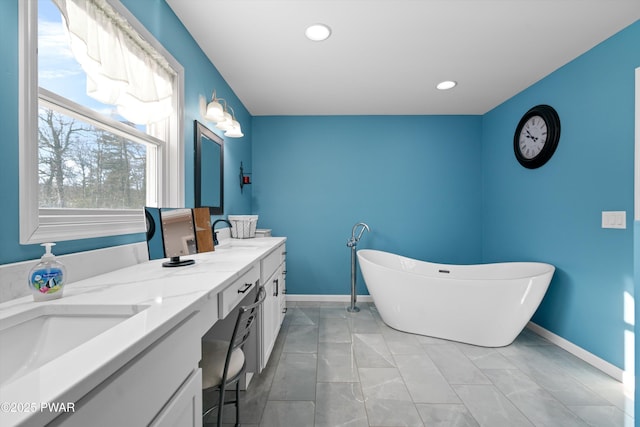 bathroom with vanity and a tub