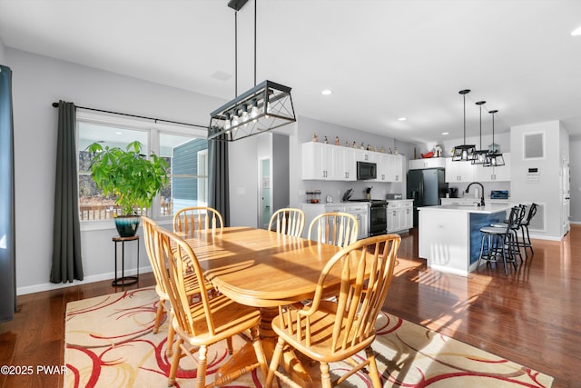 dining space featuring hardwood / wood-style flooring and sink