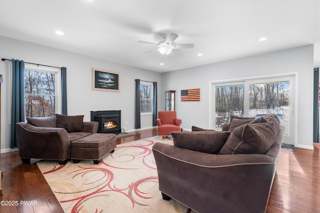 living room featuring wood-type flooring and ceiling fan