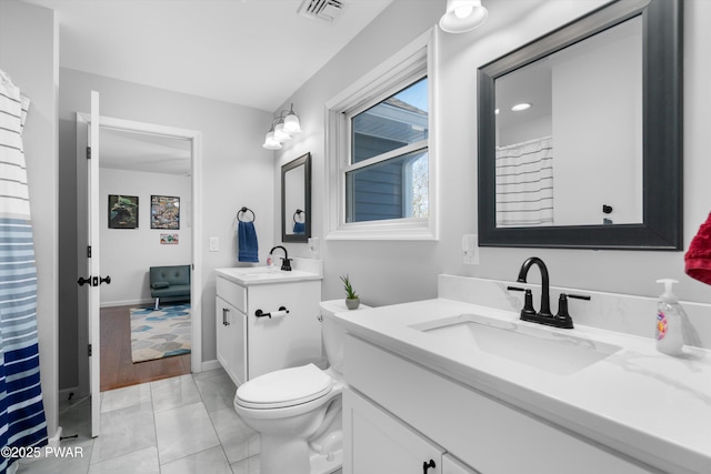 bathroom featuring vanity and toilet