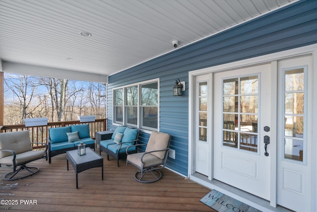 wooden terrace with an outdoor living space