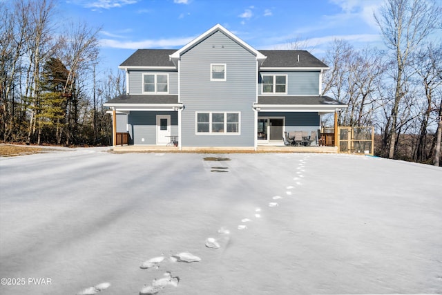 rear view of house featuring a porch