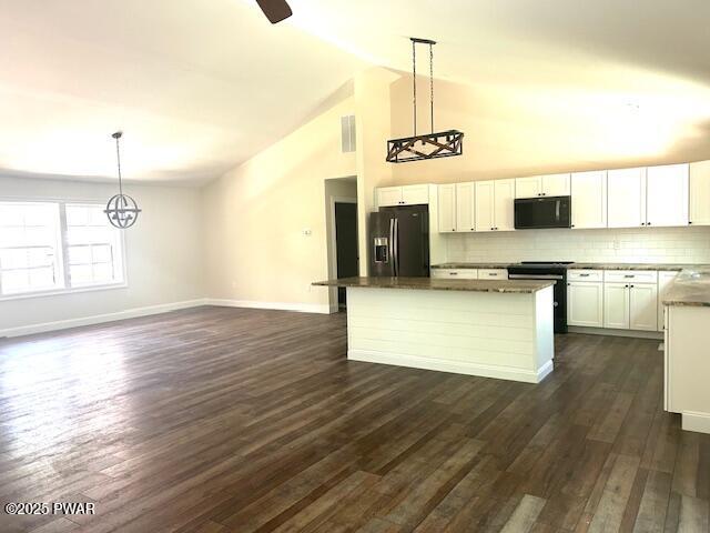 119 Lenape Dr, Milford, PA 18337 - kitchen with black appliances, white cabinetry, a center island, dark wood-style floors, and backsplash