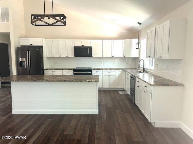 119 Lenape Dr, Milford, PA 18337 - kitchen featuring black appliances, dark wood-style floors, white cabinets, backsplash, and vaulted ceiling