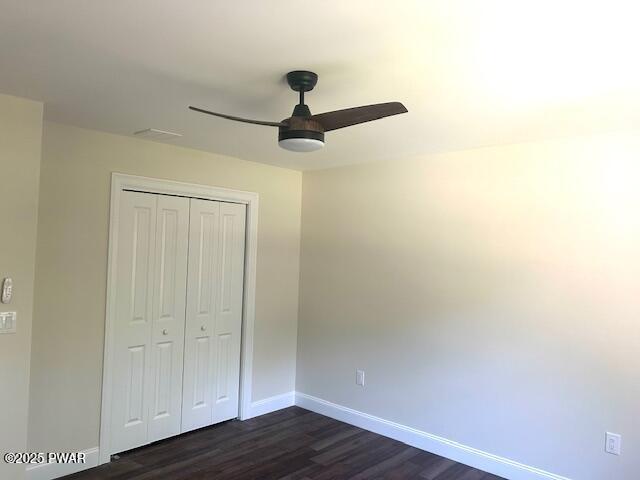 119 Lenape Dr, Milford, PA 18337 - unfurnished bedroom with dark wood-type flooring, a closet, and a ceiling fan