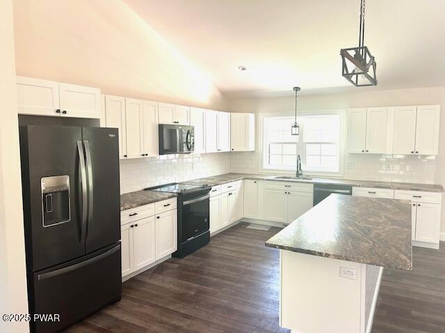 119 Lenape Dr, Milford, PA 18337 - kitchen featuring black appliances, tasteful backsplash, dark wood-type flooring, white cabinets, and lofted ceiling