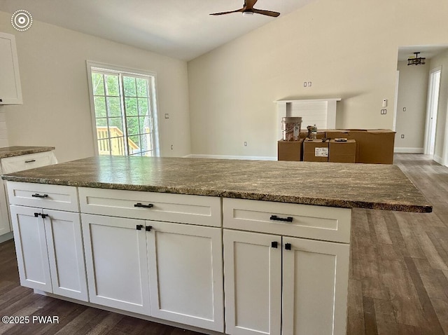 119 Lenape Dr, Milford, PA 18337 - kitchen with dark wood-style floors, ceiling fan, white cabinetry, vaulted ceiling, and dark stone countertops