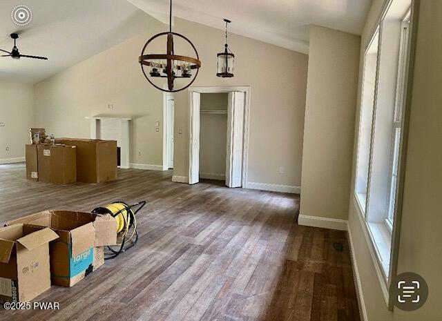 119 Lenape Dr, Milford, PA 18337 - unfurnished dining area featuring a chandelier, vaulted ceiling, a ceiling fan, and wood finished floors