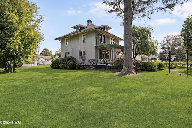 back of house featuring a yard