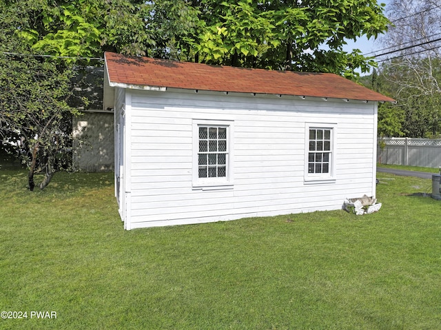 view of outbuilding featuring a yard