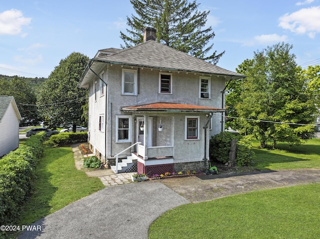 bungalow-style home featuring a front yard