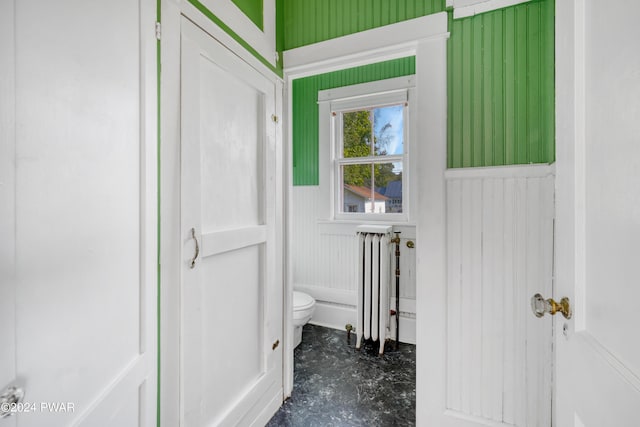 bathroom with toilet and radiator heating unit