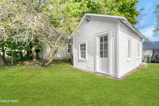 view of side of home with a yard