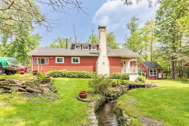114 Springbrook Ln, Greentown, PA 18426 - view of front of house featuring a chimney, an outbuilding, and a front yard