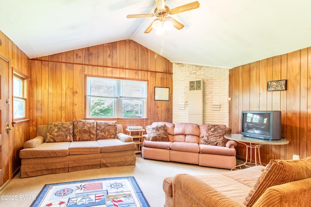 114 Springbrook Ln, Greentown, PA 18426 - living area featuring healthy amount of natural light, wood walls, vaulted ceiling, carpet, and ceiling fan