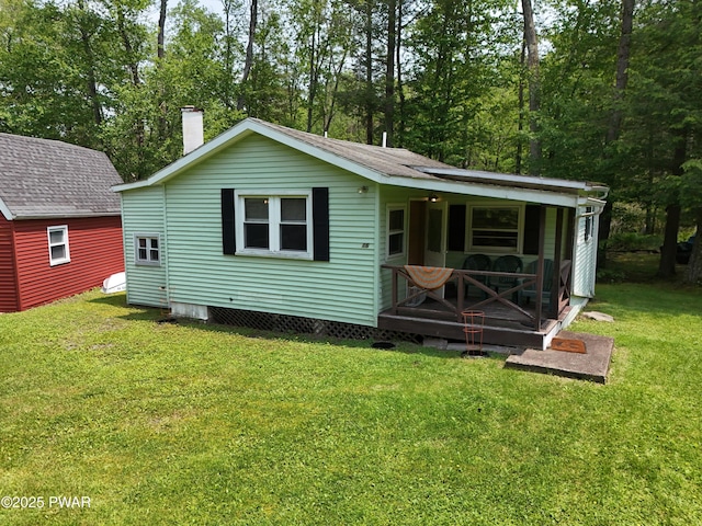 114 Springbrook Ln, Greentown, PA 18426 - rear view of house with a lawn and a chimney