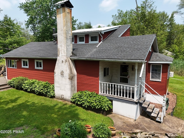 114 Springbrook Ln, Greentown, PA 18426 - view of front of property with roof with shingles, a front yard, a chimney, and covered porch