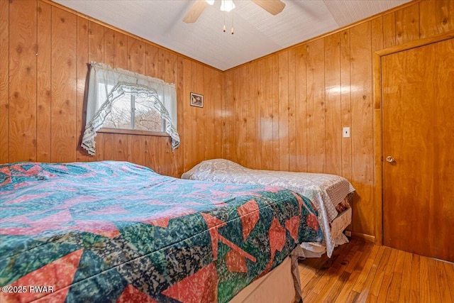 111 N Redwood Dr, Greentown, PA 18426 - bedroom featuring wooden walls, ceiling fan, and hardwood / wood-style flooring
