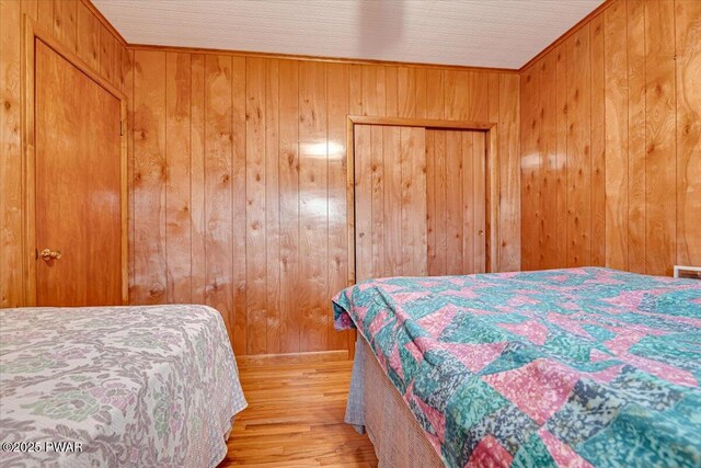 111 N Redwood Dr, Greentown, PA 18426 - bedroom with wood finished floors and wood walls