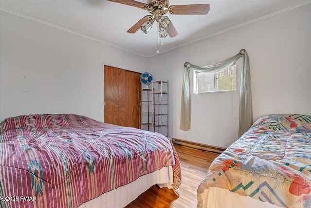111 N Redwood Dr, Greentown, PA 18426 - bedroom with wood finished floors, a baseboard heating unit, ornamental molding, and a ceiling fan
