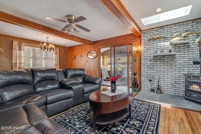 111 N Redwood Dr, Greentown, PA 18426 - living room with wooden walls, wood finished floors, beam ceiling, and a textured ceiling