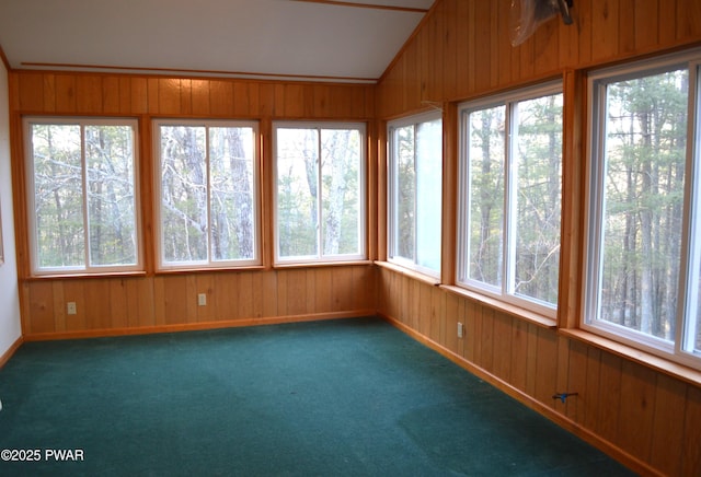 unfurnished sunroom featuring vaulted ceiling and plenty of natural light