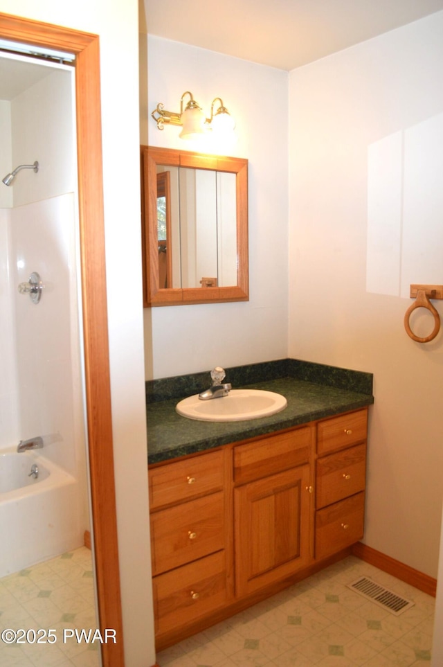 bathroom featuring tile patterned floors, visible vents, vanity, and shower / tub combination