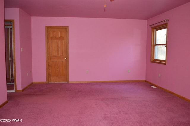 spare room featuring carpet flooring, a ceiling fan, and baseboards