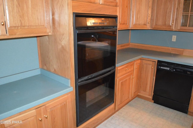 kitchen with light floors and black appliances