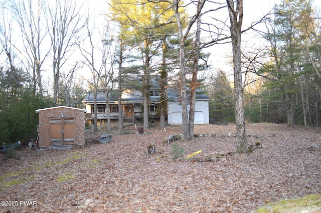 view of front facade with an outdoor structure, a garage, and a shed