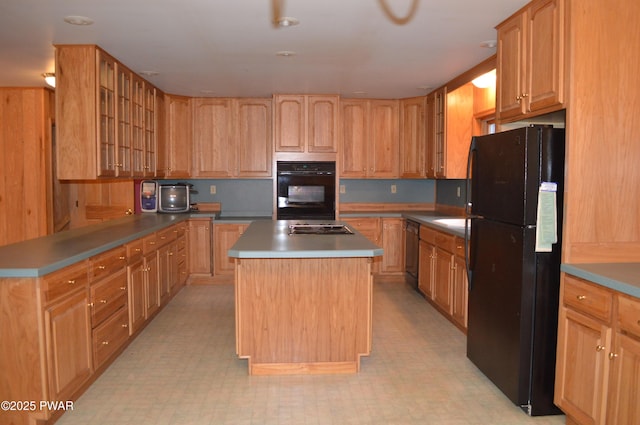 kitchen featuring dishwashing machine, glass insert cabinets, light floors, and freestanding refrigerator