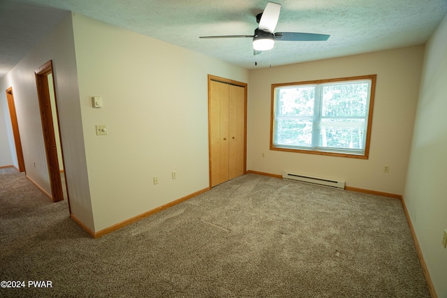 carpeted empty room featuring ceiling fan, a textured ceiling, and a baseboard radiator