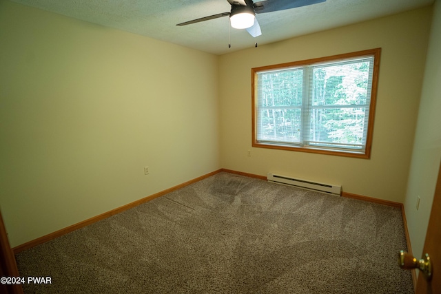 spare room with carpet, baseboard heating, and ceiling fan