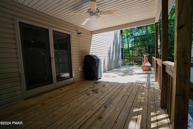 deck featuring area for grilling and ceiling fan