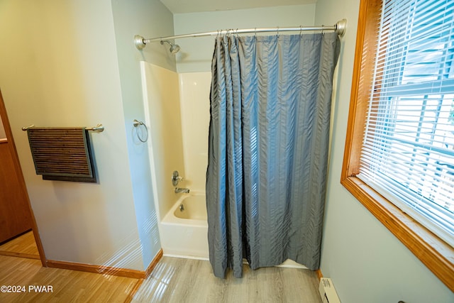 bathroom with hardwood / wood-style floors and shower / bath combination with curtain