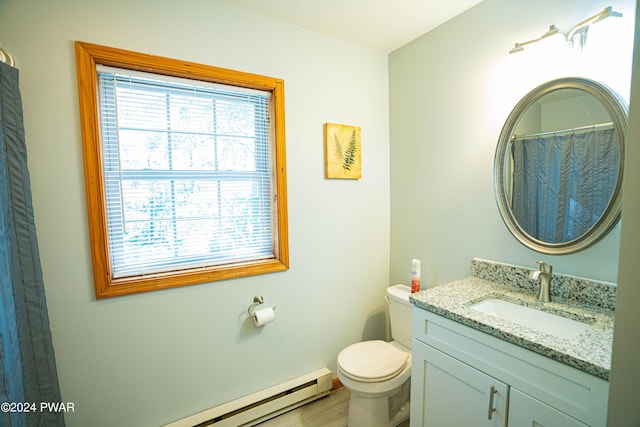 bathroom with vanity, toilet, and a baseboard radiator