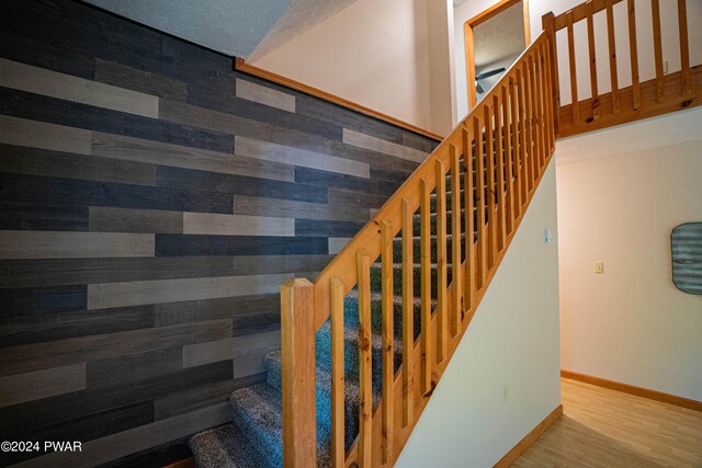 stairs with wood-type flooring