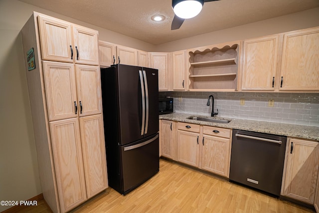 kitchen featuring black appliances, decorative backsplash, light brown cabinets, and sink