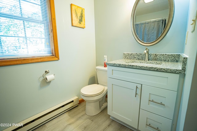 bathroom featuring hardwood / wood-style floors, vanity, toilet, and a baseboard heating unit