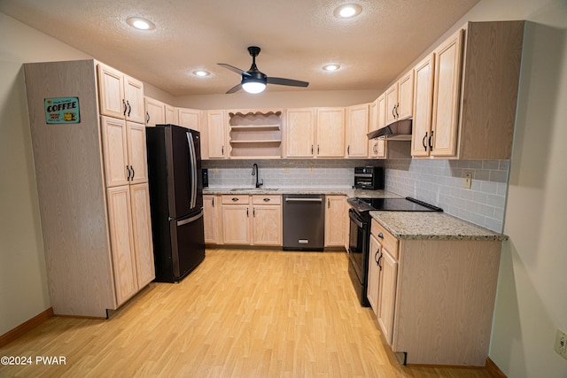 kitchen featuring decorative backsplash, light brown cabinetry, ceiling fan, black appliances, and light hardwood / wood-style floors