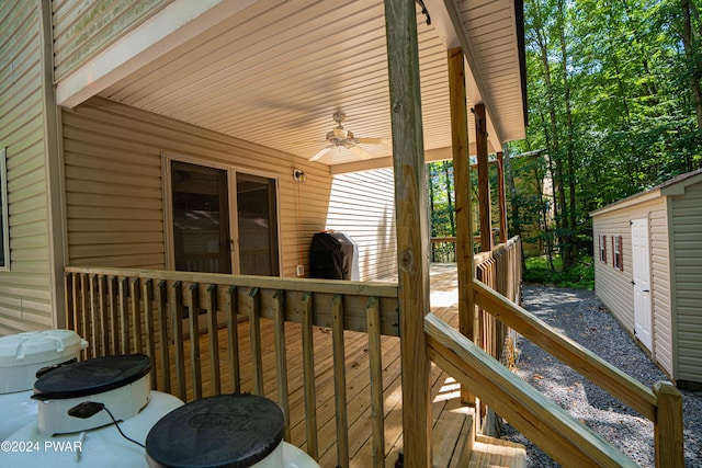 deck featuring area for grilling and ceiling fan