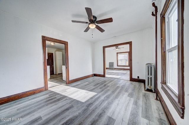 empty room with radiator and light wood-type flooring