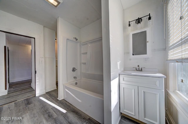 bathroom with hardwood / wood-style flooring, vanity, and shower / bath combination