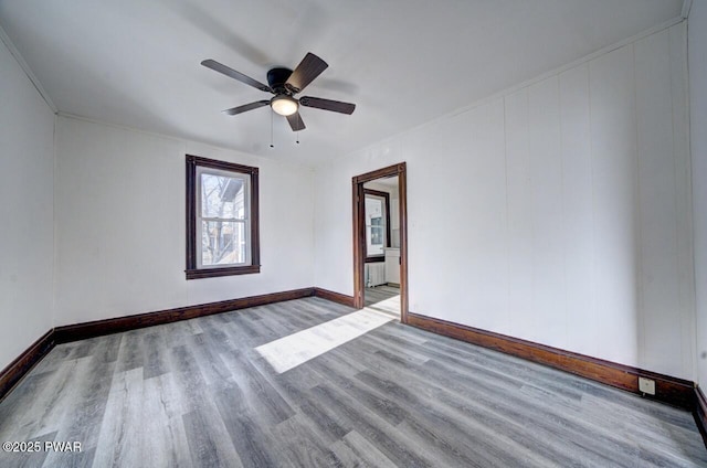 unfurnished room featuring ceiling fan, radiator, and light wood-type flooring